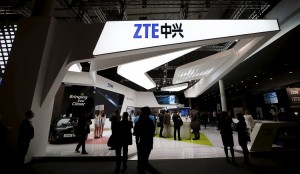 Visitors check out products at the ZTE stand at the Mobile World Congress in Barcelona, in this February 24, 2014 file photo.  ZTE is expected to release final results this week.    REUTERS/Albert Gea   GLOBAL BUSINESS WEEK AHEAD PACKAGE - SEARCH "BUSINESS WEEK AHEAD MARCH 23" FOR ALL IMAGES